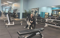 M Fitness owner Lyne Monette with gym mascot and beloved companion, Koda in the newly expanded workout area.
