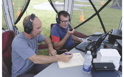 Radio operators make contact with other stations in North America. One person is on the radio while the other logs the contact on the computer. Photo: Christian Rochefort