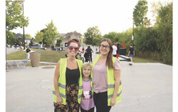 Both hosts of the event (Gabrielle Rivais on the left, Cassandra Bernier on the right) are enjoying themselves, taking photos with a participant (Olivia Cornish).