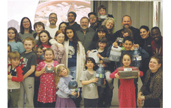 Families holding up their gardens at the Pollinate event at Eardley Elementary School (JO) Photo: Jude Osmond