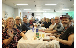 Guests at table two are enjoying a good time at the event and taking in the live music. Photo: Jude Osmond