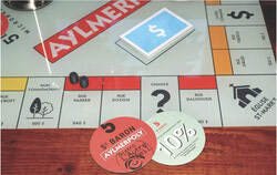 Custom “Aylmerpoly” coasters that give players 10% off beer cans to-go at Bistro L’Autre Oeil. Photo: Christian Rochefort