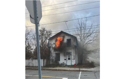 Old Aylmer home located at 81 rue du Couvent with flames blazing from the second-floor window, taken by a resident passing by the home. Photo: Courtesy
